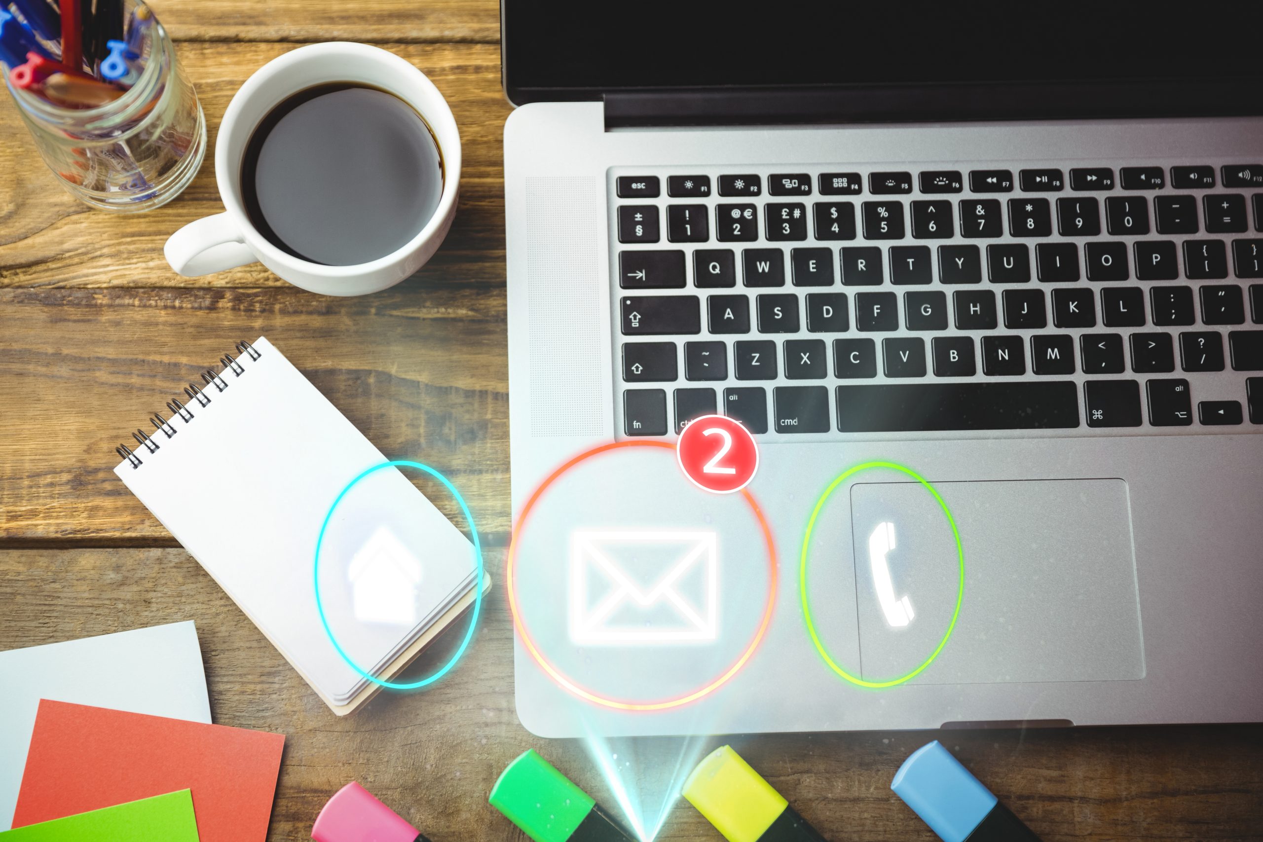Composite image of laptop, notebook and coffee on a desk with contact icons